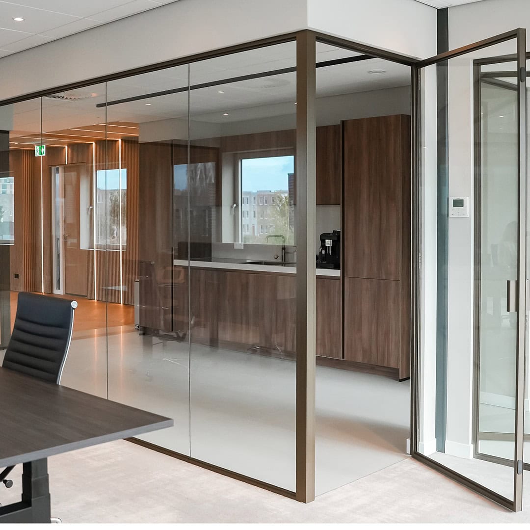 Steel interior door with glass panels and bespoke finish in a modern office interior.
