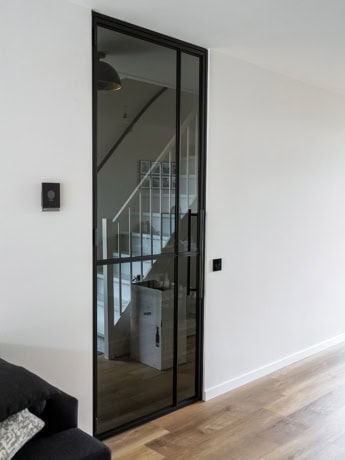 High-quality steel directional door with black frame and spacious glazing, perfect for modern interior projects.