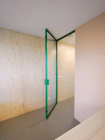 Secure glass partition with steel frame and custom-made doors for modern interiors.