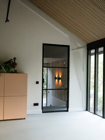 Beautiful steel partition with custom-made door in a modern interior, ideal for stylish home layouts and office spaces.