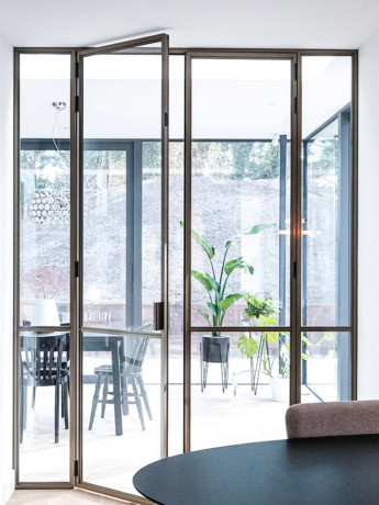 High-quality steel sliding door for interior and exterior, customised and modern design, durable and secure steel walls, elegant locking options, Aluwdoors specialist.