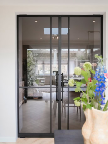 Large black steel sliding door with glass, perfect for modern interiors.