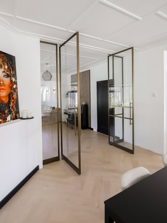 Glass steel partition with gold frame in modern interior.