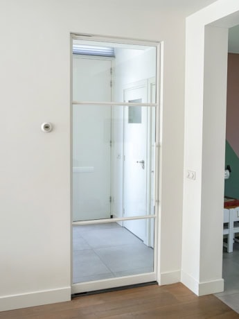 Glass steel door with white frame for modern home decoration.