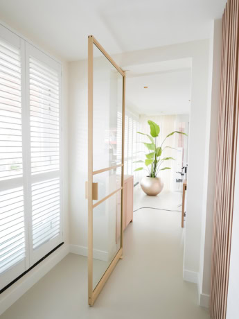 Sleek steel door with wooden frame, perfect for modern interiors and room layouts, custom-made by Aluwdoors.