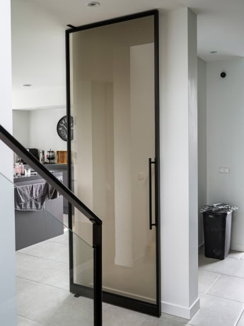 Robust steel door with glass panel, customised for modern interior designs, perfect for privacy and style.