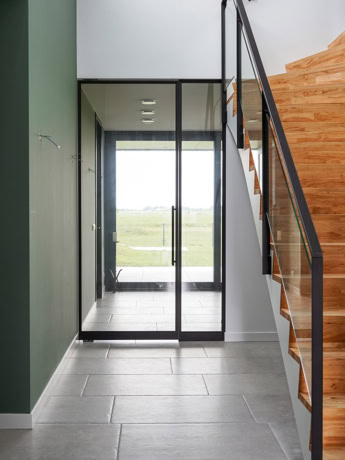 Robust steel sliding door with glass panels for modern interior finishing, perfect for entrance or as a separation between living and kitchen area.
