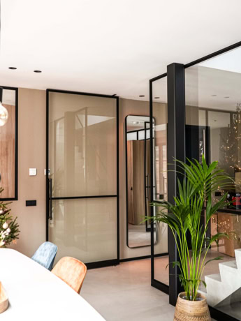 Design steel partition and doors with frosted glass and black metal frame in modern interiors.