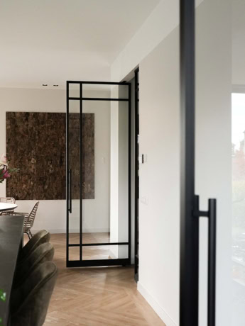 Modern steel sliding door with sleek black frame, perfect for a contemporary interior finish.