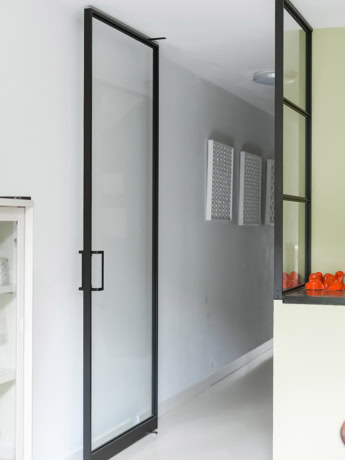 Bespoke glass steel partition door with black metal frame for indoor use.
