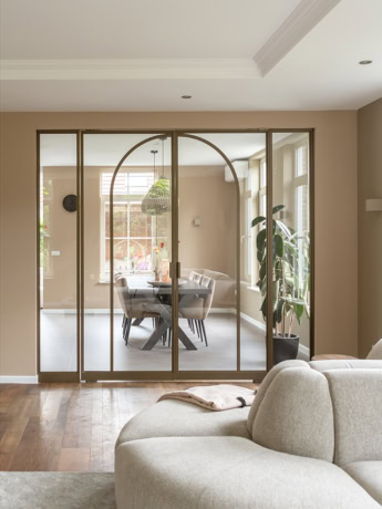 Bronze pivot door with arched rod