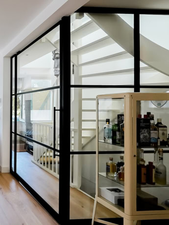 Modern steel partition with glass panels in a house.
