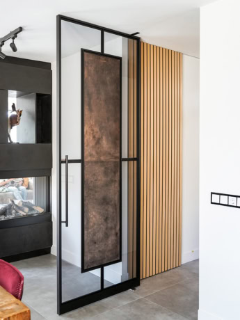 High-quality steel door with black frame and wooden accent, custom-made for modern interiors.