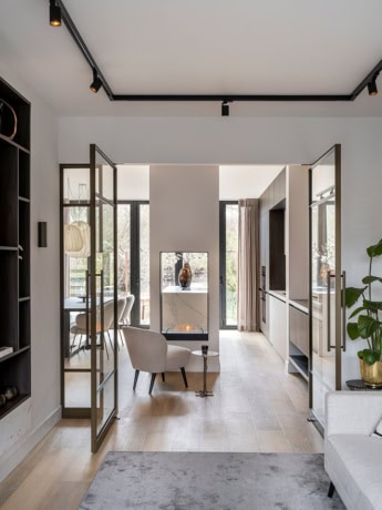 Luxury steel partitions with glass doors in a modern living room for an open and elegant look.