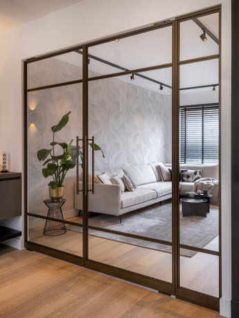 Aluwdoors double pivot door bronze in room