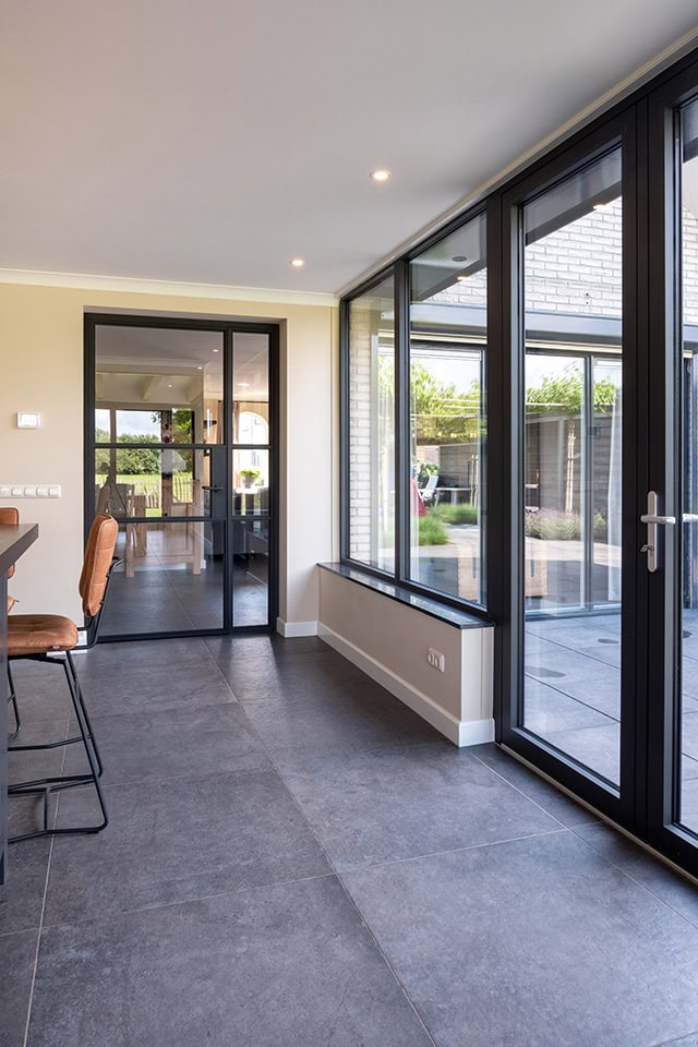 Sturdy steel implicated doors and compact glass walls for a modern look.