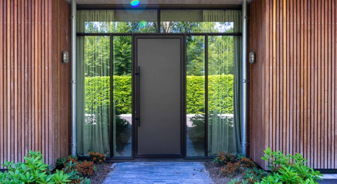 High-quality steel door with side panels for a modern and durable entrance, perfectly tailored by Aluwdoors.