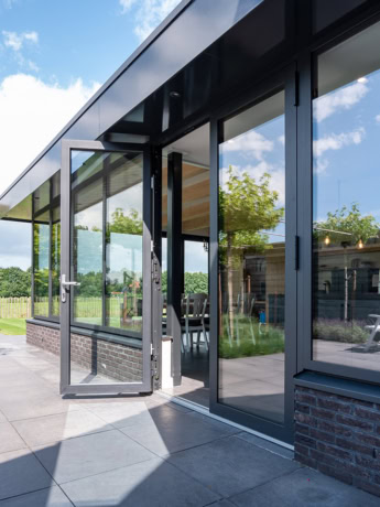Sleek steel garden door and large glass windows for modern home, high quality finish with black metal frame.
