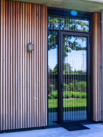 High quality steel front door with large glass and black frame, modern design, custom made, perfect for modern home, durable steel doors and walls, aluwdoors.co.uk.