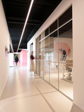 Glass wall with steel door in modern office building, transparent separation and stylish architecture.