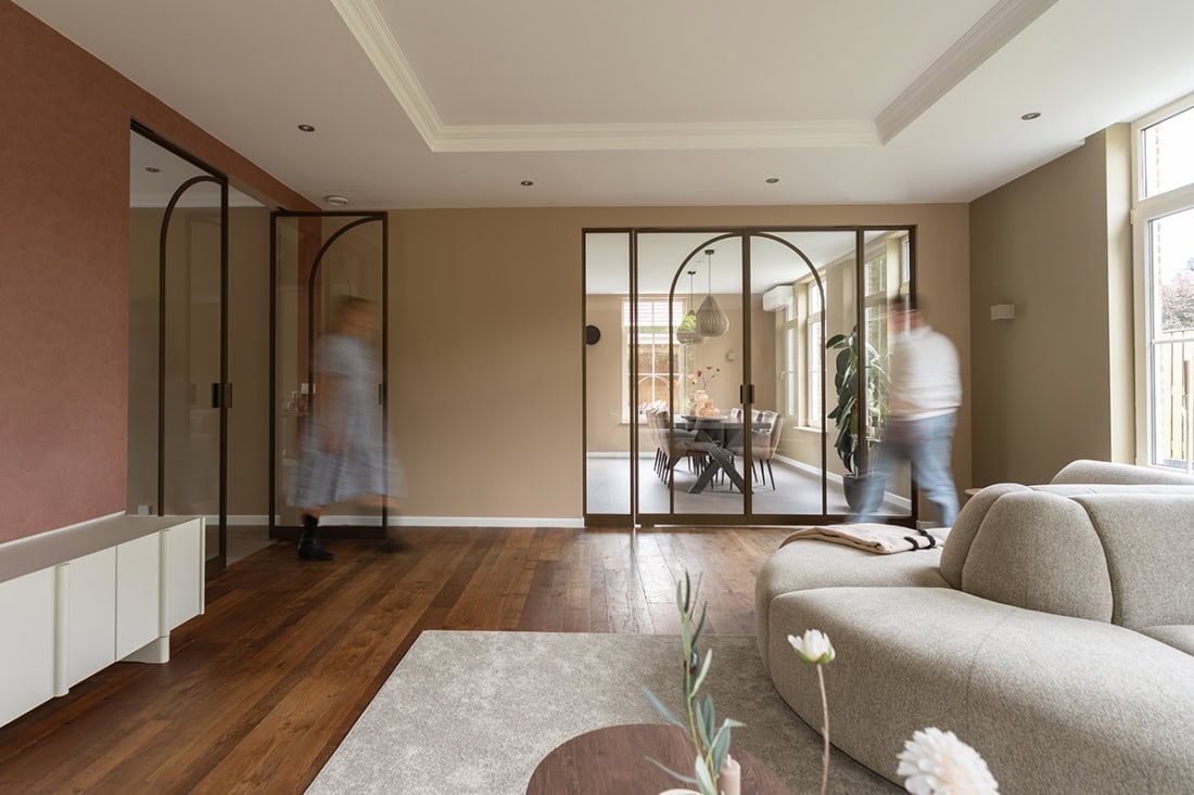 Modern steel partition with glass doors in a living room, custom-made for stylish interior partitions.