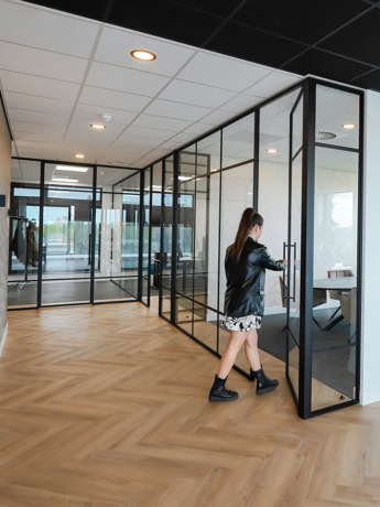 Elegant bespoke steel partitions and glass doors for a modern office environment.