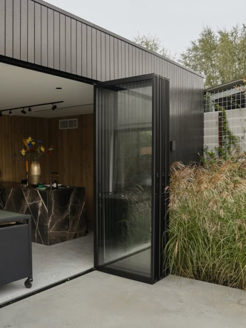 Custom steel sliding door with glass panels for modern living spaces.