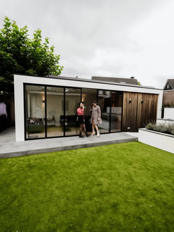 Modern steel sliding doors and bespoke walls for a stylish garden or living space.