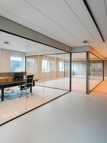 Steel partition wall with glass panels for office space, sleek design and soundproofing.
