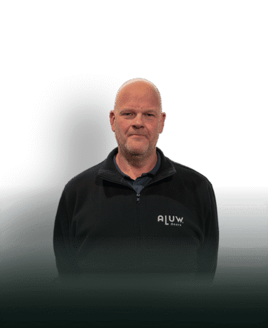 Modern man in black ALUW doors jacket standing against a plain background.